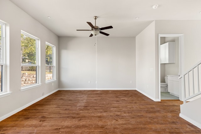 unfurnished room with dark hardwood / wood-style floors and ceiling fan