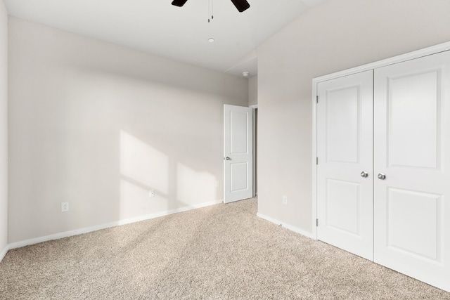 unfurnished bedroom featuring ceiling fan, a closet, and carpet flooring