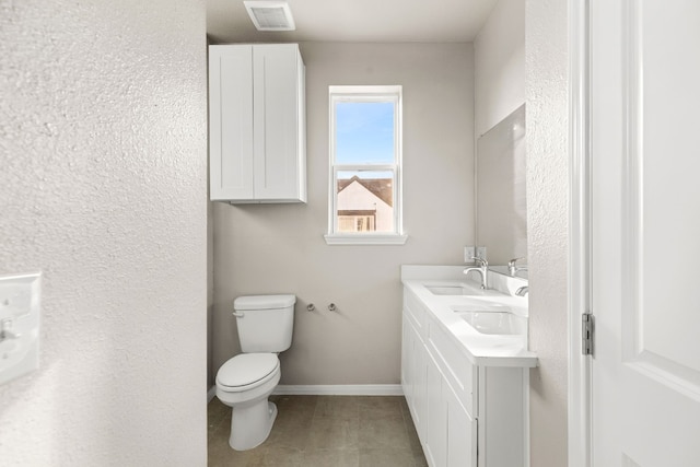 bathroom featuring vanity, tile patterned flooring, and toilet