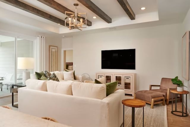 living room featuring light hardwood / wood-style flooring, a chandelier, and beam ceiling