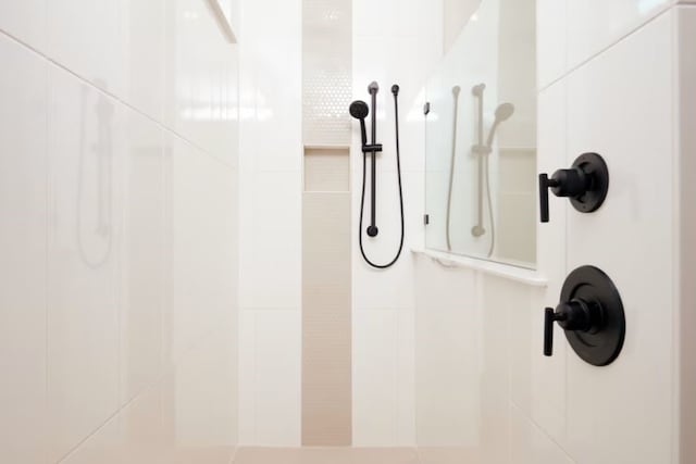 interior details featuring a tile shower