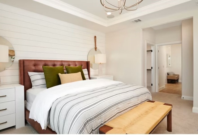 bedroom with ornamental molding, light carpet, wood walls, and an inviting chandelier