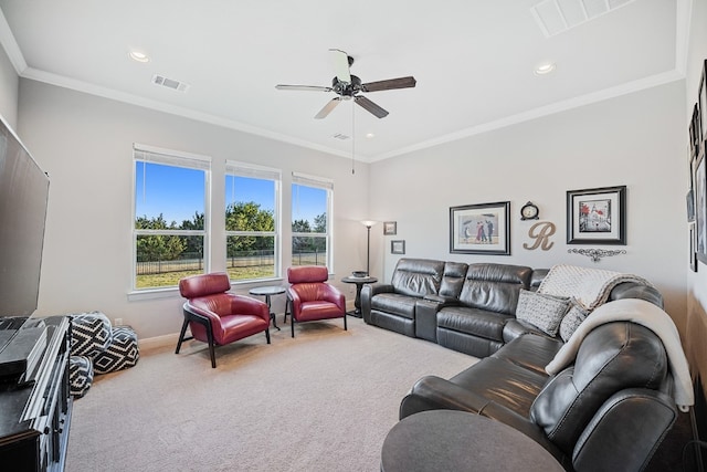 carpeted living room featuring ceiling fan and ornamental molding