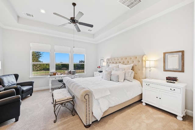 bedroom featuring a tray ceiling, ceiling fan, and light colored carpet