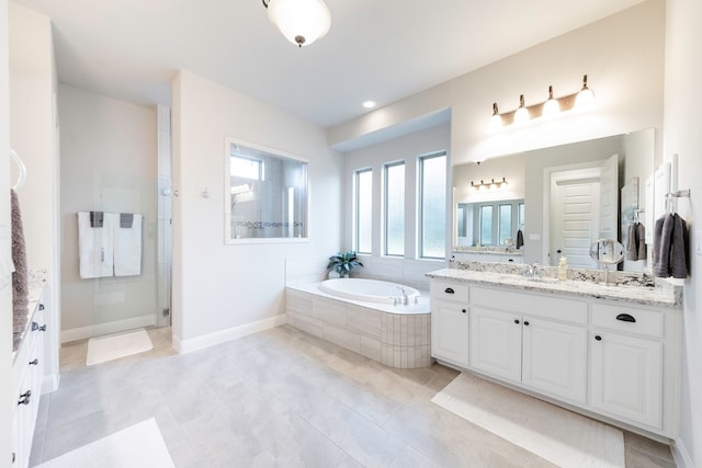 bathroom with tile patterned flooring, vanity, and plus walk in shower