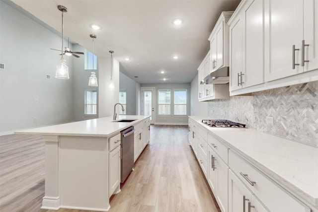 kitchen featuring a kitchen island with sink, white cabinets, sink, ceiling fan, and appliances with stainless steel finishes