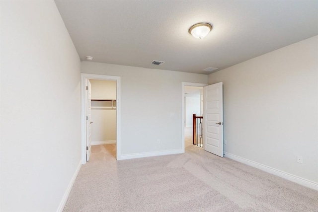 unfurnished bedroom with a spacious closet and a closet