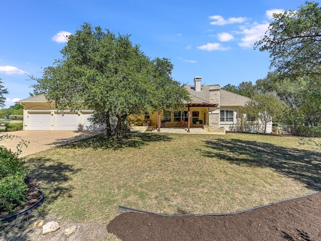 26801 Founders Pl, Spicewood, TX 78669 - view of front facade with driveway, a front lawn, a garage, covered porch, and stucco siding