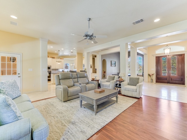 living room featuring light wood-type flooring and ceiling fan