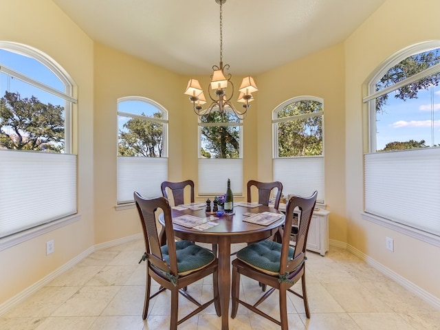 26801 Founders Pl, Spicewood, TX 78669 - dining room with a chandelier, light tile patterned flooring, and baseboards