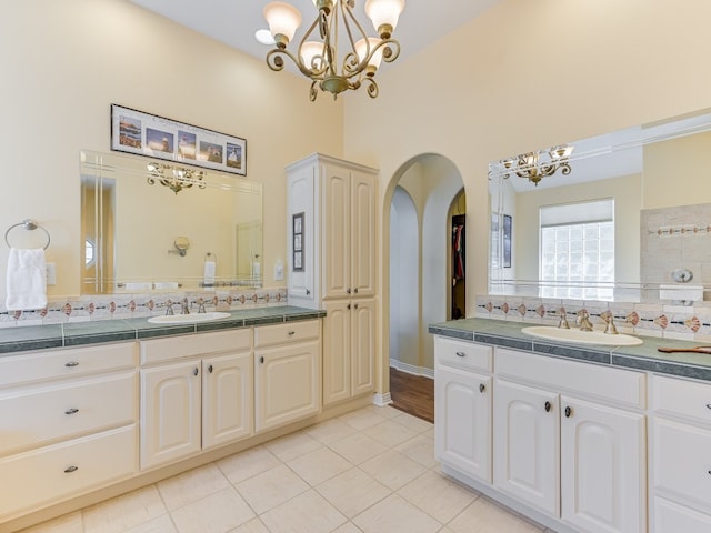 bathroom with tile patterned flooring, backsplash, and vanity