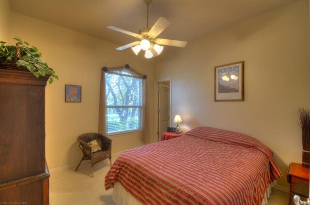 bedroom featuring ceiling fan and light colored carpet