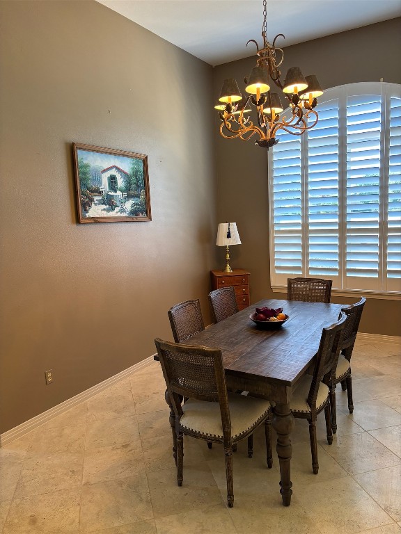 26801 Founders Pl, Spicewood, TX 78669 - dining room with a chandelier and baseboards