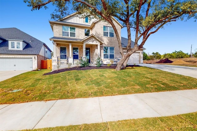 craftsman-style house featuring a garage, covered porch, and a front yard