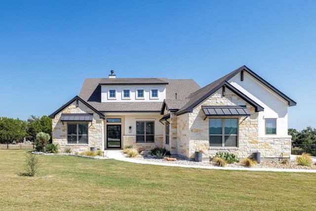 501 Francis Ct, Liberty Hill, TX 78642 - view of front of home with stone siding, a shingled roof, a standing seam roof, and a chimney
