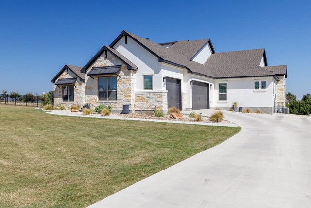 501 Francis Ct, Liberty Hill, TX 78642 - view of front of home with an attached garage, stone siding, concrete driveway, stucco siding, and roof with shingles
