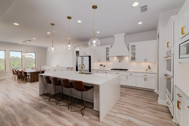 501 Francis Ct, Liberty Hill, TX 78642 - kitchen featuring premium range hood, white appliances, light countertops, white cabinets, and recessed lighting
