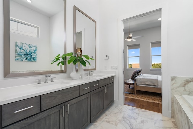 bathroom featuring ceiling fan, a wealth of natural light, and vanity