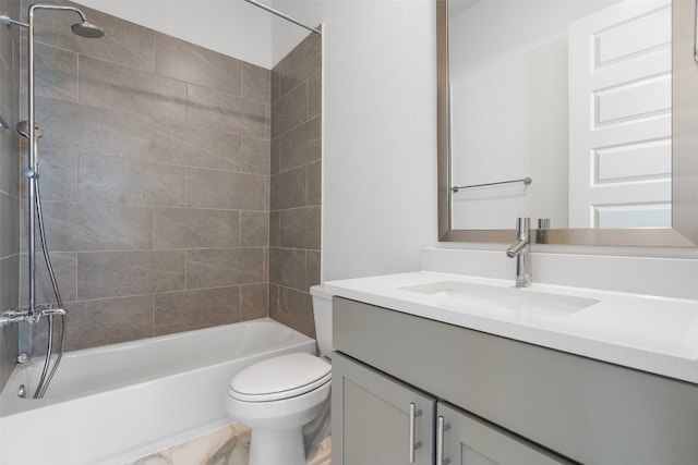 full bathroom with vanity, tiled shower / bath combo, and toilet