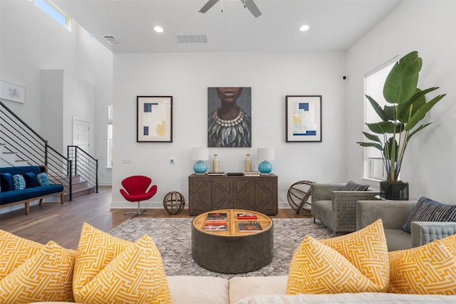 living room with ceiling fan and wood-type flooring