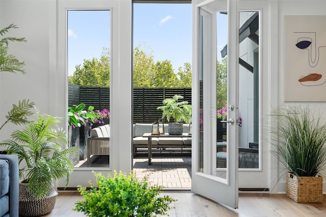 doorway with french doors and light hardwood / wood-style flooring