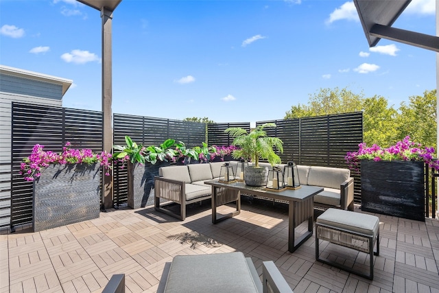 wooden terrace featuring an outdoor living space and a patio