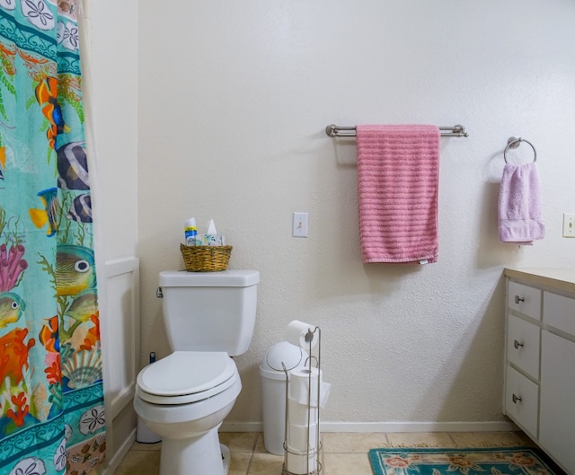 bathroom featuring a shower with curtain, vanity, toilet, and tile patterned floors