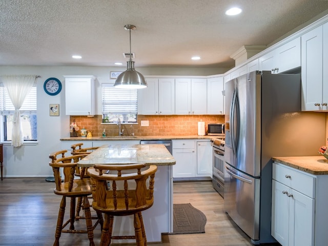 kitchen with plenty of natural light, sink, and white cabinetry