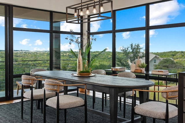 sunroom featuring a chandelier