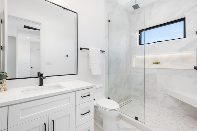 bathroom with vanity, toilet, and an enclosed shower