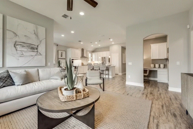 living room featuring ceiling fan and light wood-type flooring