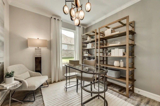 interior space with light hardwood / wood-style floors, crown molding, and a chandelier