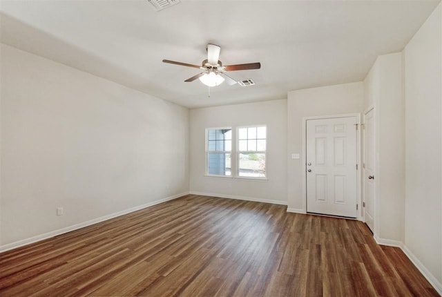 empty room with dark hardwood / wood-style floors and ceiling fan