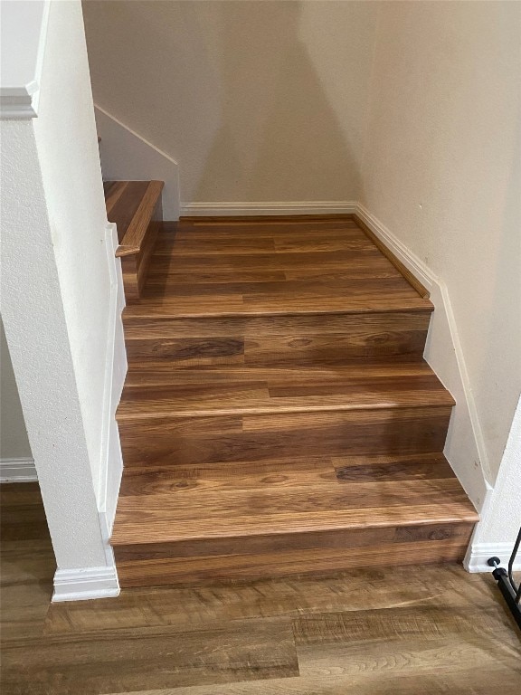 stairs featuring hardwood / wood-style floors