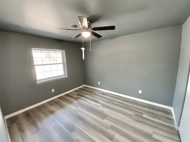 spare room with ceiling fan and hardwood / wood-style floors