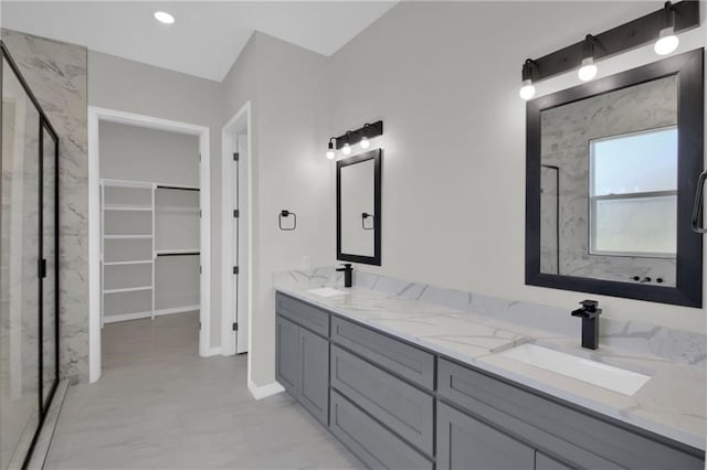 bathroom featuring vanity and a shower with shower door