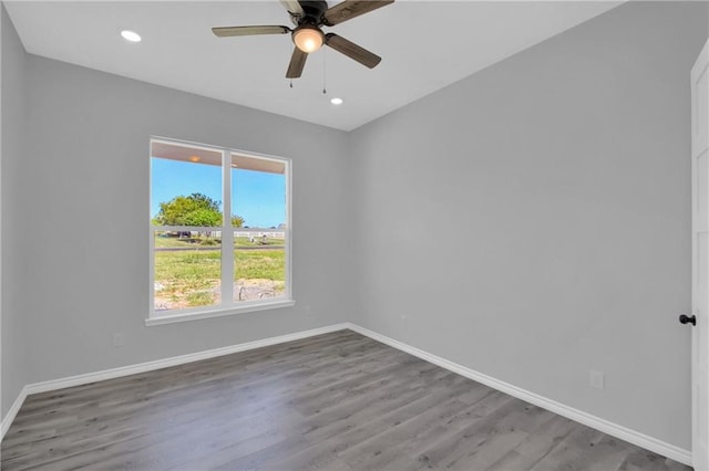 spare room featuring hardwood / wood-style flooring and ceiling fan