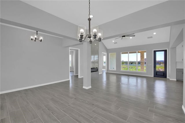 unfurnished living room featuring ceiling fan with notable chandelier, hardwood / wood-style flooring, and vaulted ceiling