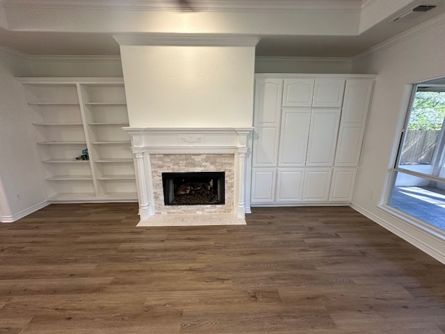 unfurnished living room featuring ornamental molding, a fireplace, and dark hardwood / wood-style flooring