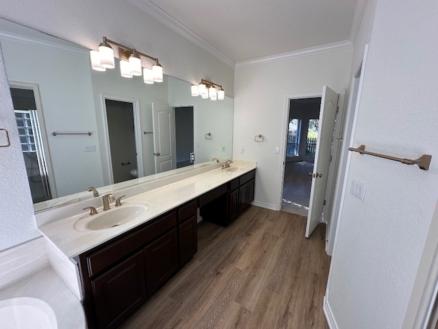 bathroom featuring vanity, crown molding, hardwood / wood-style floors, and toilet