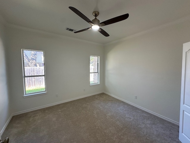 carpeted spare room featuring ornamental molding and ceiling fan