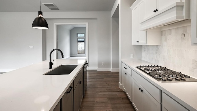 kitchen featuring a sink, visible vents, light countertops, stainless steel gas stovetop, and custom range hood