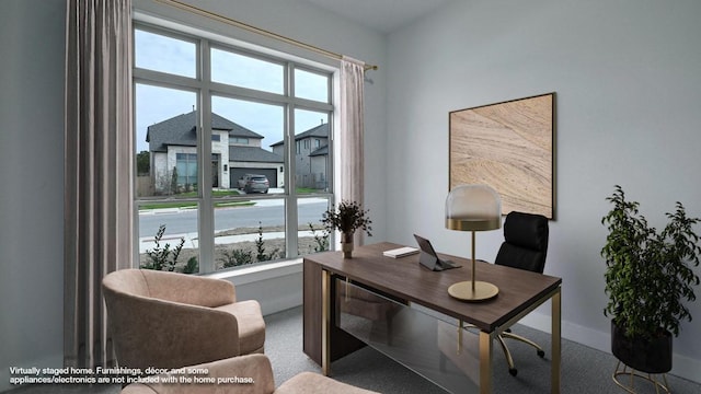 home office featuring carpet, a residential view, and baseboards