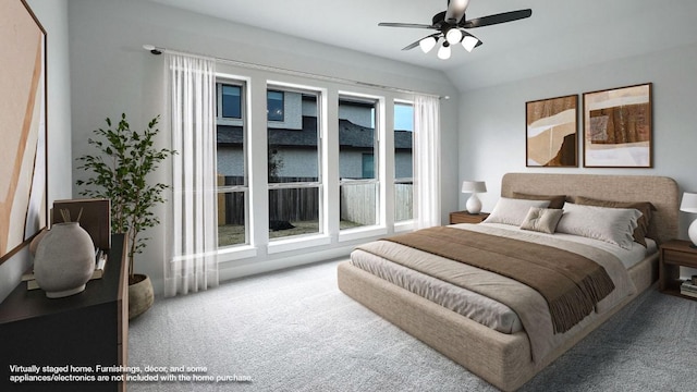 carpeted bedroom featuring vaulted ceiling and a ceiling fan