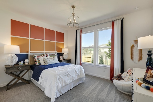 carpeted bedroom featuring a chandelier