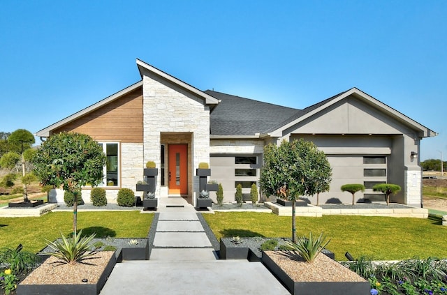 contemporary home with a garage and a front yard