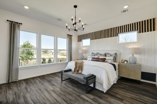 bedroom featuring an inviting chandelier and dark hardwood / wood-style flooring