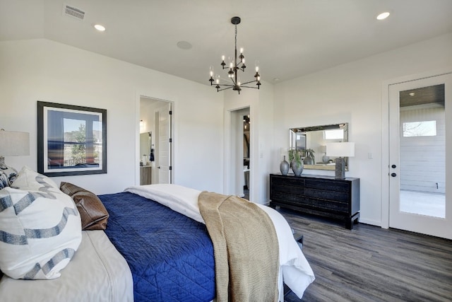 bedroom featuring multiple windows, ensuite bath, vaulted ceiling, and dark hardwood / wood-style flooring