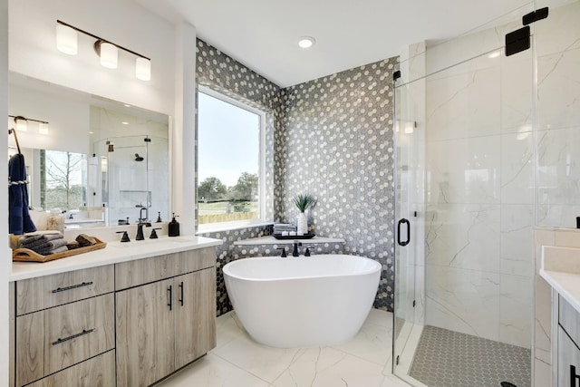 bathroom with vanity, plus walk in shower, and tile walls