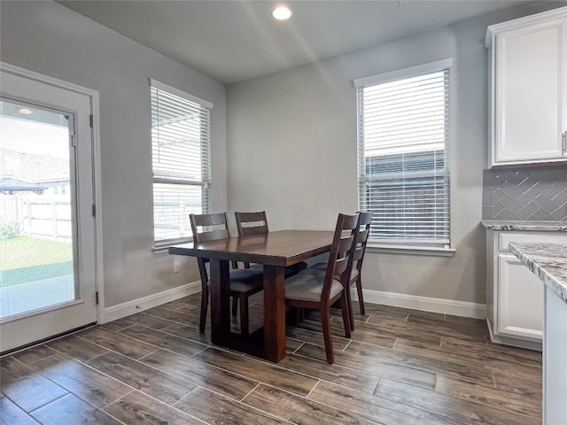 dining space with dark wood-type flooring